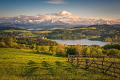 Panorama of snowy Tatra mountains and castle in Czorsztyn during spring sunset, Malopolskie, Poland
